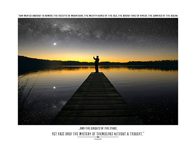 Man standing on jetty at night with phone, starry sky; Button for Augustine Gallery.