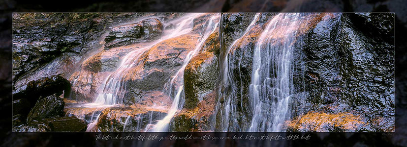 Close up water of falls with shiny rocks. Button for Close Gallery.